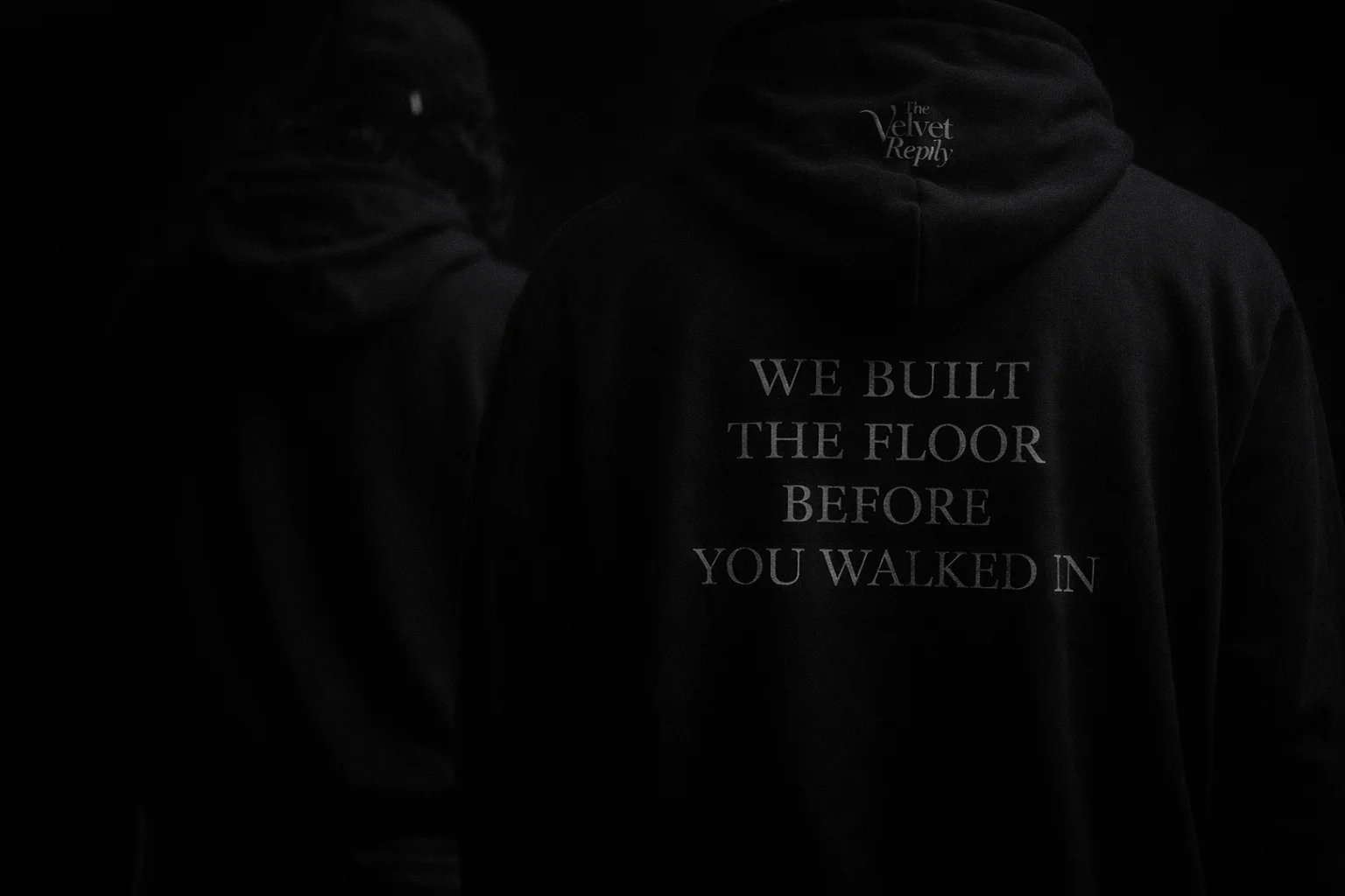 Black hoodie with We Built The Floor Before You Walked In text on back