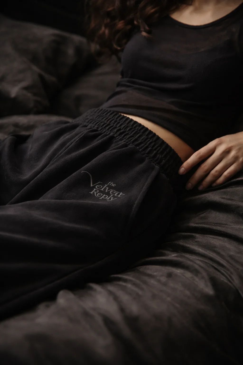 Dark grey velour joggers with The Velvet Reply thigh embroidery